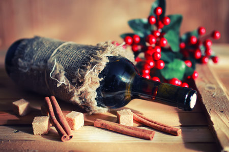 Decorated bottle of fine wine on a wooden table with glassの写真素材