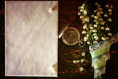 old shabby wooden painted background and a beautiful bouquet of fresh white flowers lily of the valleyの写真素材