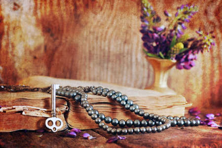 old tattered book on a wooden table textural found an artifact of historyの写真素材