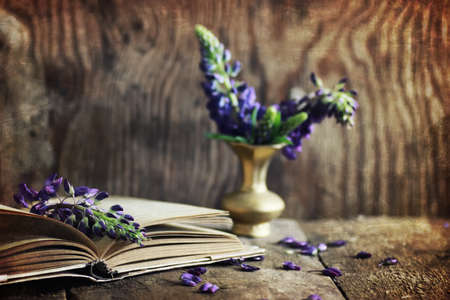 old tattered book on a wooden table textural found an artifact of historyの写真素材