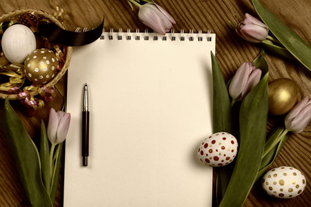 colorful painted eggs and tulips on  wooden table   for Easter
