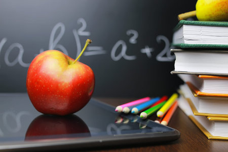 educational concept in the photos as a pile of books and a fresh apple as a source of vitamins for studyの写真素材