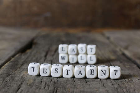 small wooden blocks with letters on the old worn wooden tableの写真素材