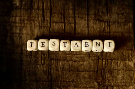 small wooden blocks with letters on the old worn wooden tableの写真素材