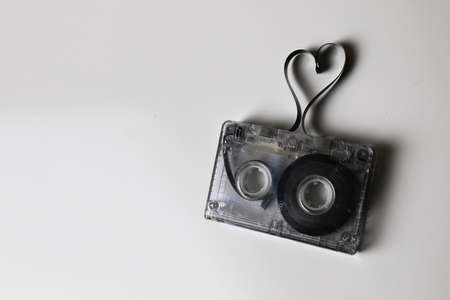 audiocassette retro music and film of her folded in the shape of a heart and headphonesの写真素材