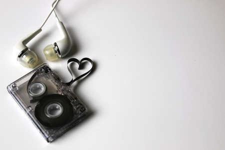 audiocassette retro music and film of her folded in the shape of a heart and headphonesの写真素材
