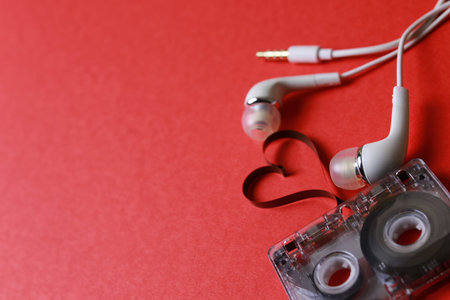 audiocassette retro music and film of her folded in the shape of a heart and headphonesの写真素材