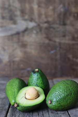 ripe juicy buttery avocado on   wooden table