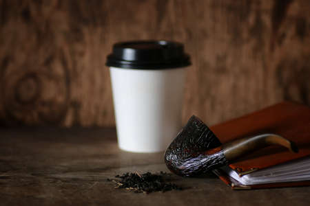 old cherry pipe tobacco smoking on a wooden tableの写真素材
