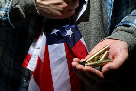 cases from the military cartridges in the hands of the men of war conceptの写真素材