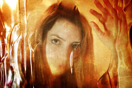 portrait of a woman through frosted glassの写真素材