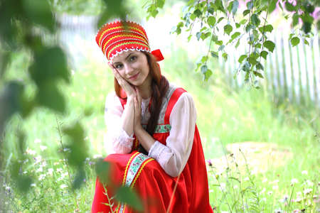beautiful young girl in traditional red dressの写真素材