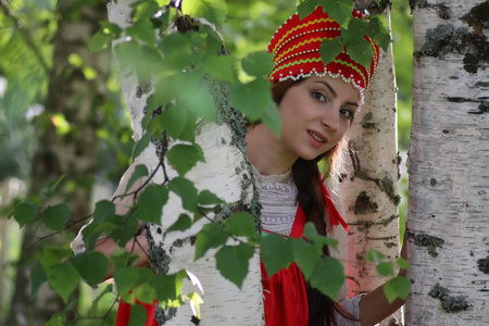beautiful young girl in traditional red dress Slavic cultureの写真素材