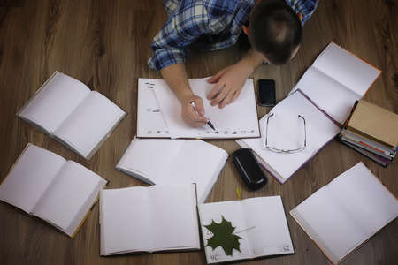 man working with book on the floor, education and business conceptの写真素材