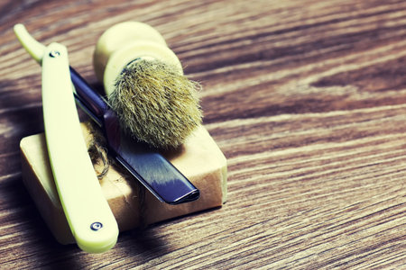 Men's cosmetics shaving brush and razor on a wooden backgroundの写真素材