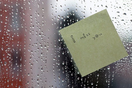 background rain drops on glass and a sticker with the inscription on it