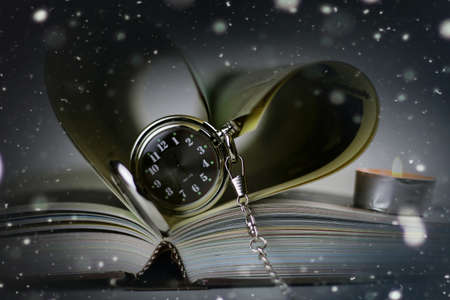 book made up in shape of heart and pocket retro watches candlesの写真素材