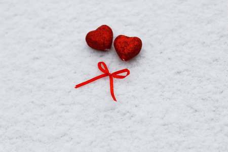 Snowy day shape of hearts red color in winter dayの写真素材