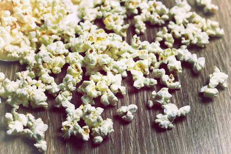 a scattering of popcorn on the wooden floor while watching a movieの写真素材