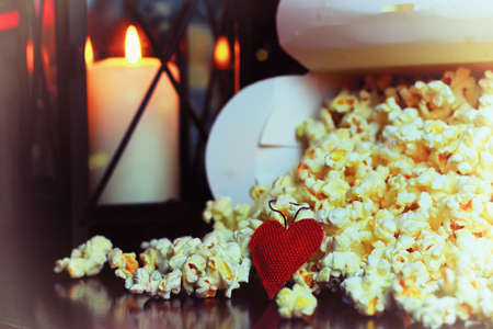 a scattering of popcorn on the wooden floor while watching a movieの写真素材