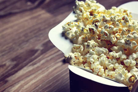 a scattering of popcorn on the wooden floor while watching a movieの写真素材