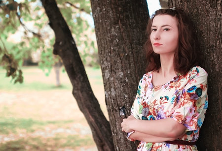 portrait of a happy young girl of European appearance with warm spring sunny dayの写真素材