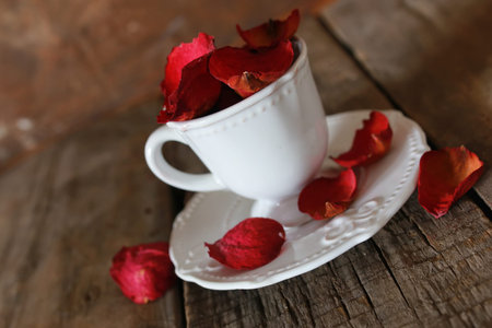 small white cup of hot drink on a wooden textural backgroundの写真素材
