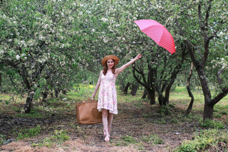 portrait of a cute beautiful girl of European appearance on nature in a summer dayの写真素材