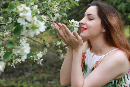 portrait of a cute beautiful girl of European appearance on nature in a summer dayの写真素材
