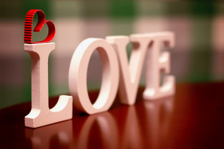 the word love made up of wooden white letters on the table