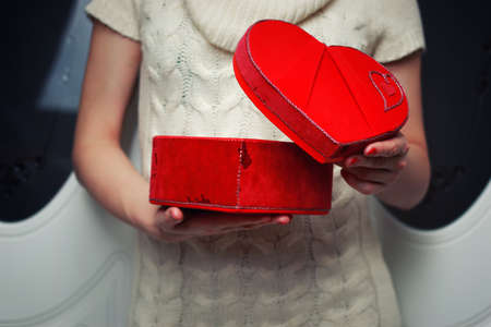 object red heart-shaped hands holding a young personの写真素材