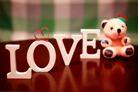 the word love made up of wooden white letters on the table
