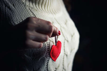 object red heart-shaped hands holding a young personの写真素材