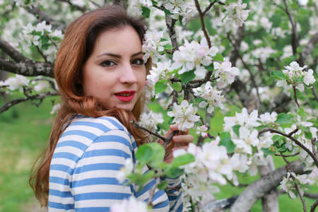 portrait of a cute beautiful girl of European appearance on nature in a summer dayの写真素材