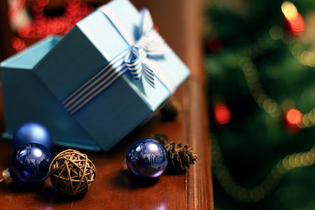 Christmas gift in the blue box with a bow with a bright-colored toys