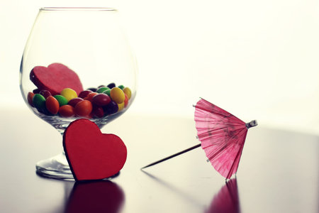 colored jelly beans and candy in a glass transparent glass on a table