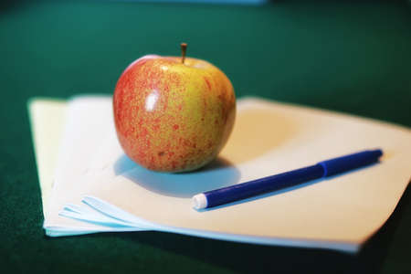 textbooks to prepare for the new academic year at school and an appleの写真素材