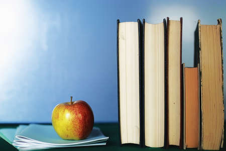 textbooks to prepare for the new academic year at school and an appleの写真素材