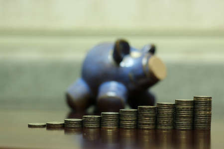 a lot of stacks of coins increasing yellow gradually the concept of progress and growthの写真素材