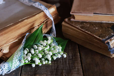 old shabby wooden painted background and a beautiful bouquet of fresh white flowers lily of the valleyの写真素材