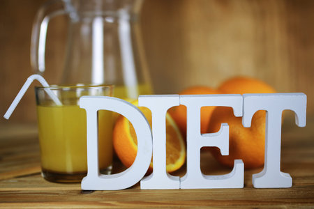 Delicious fresh orange juice on a wooden textural background