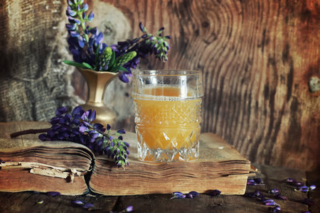 old tattered book on a wooden table textural found an artifact of historyの写真素材