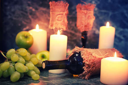 Still on the table a bottle of wine and a bouquet of beautiful pink rosesの写真素材