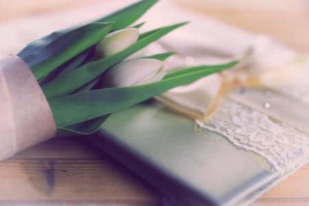 beautiful still life of delicate bouquets of tulips and green applesの写真素材