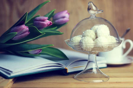 still life on the texture old wooden table bouquet of beautiful tulips an open bookの写真素材