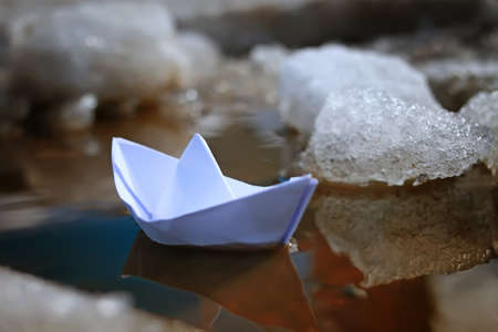small paper folded boat origami method in a spring brook in the parkの写真素材