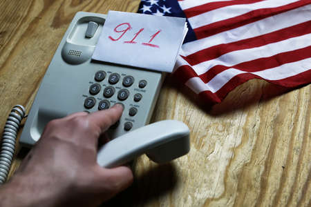 electronic home phone on a wooden table concept rescue callの写真素材