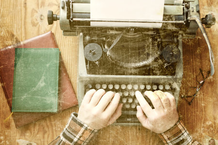 Retro old typewriter on the texture wooden table in the office
