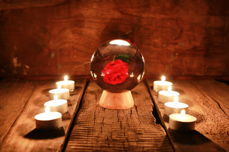crystal ball for predicting the fate and supernatural action on the table from the old mahogany with candles and cardsの写真素材