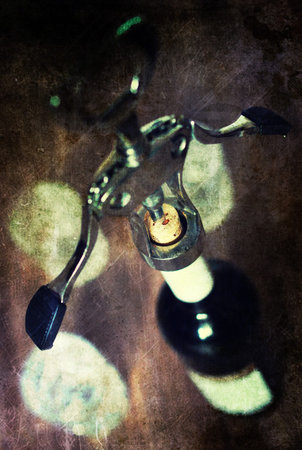 Metal corkscrew with a bottle of delicious wine and glasses for himの写真素材